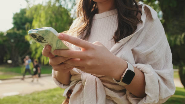istock Close-up of young woman's hands using mobile phone 1456352368