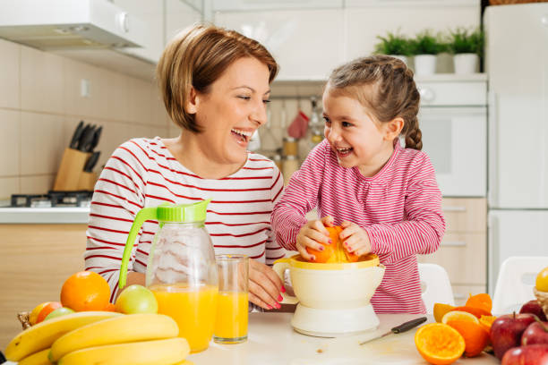 istock Family making fresh orange juice 1456352476