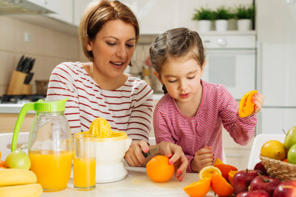 istock Family making fresh orange juice 1456352548