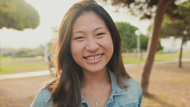 istock Close up, young woman posing at camera while standing in park. Looking at camera 1456354054