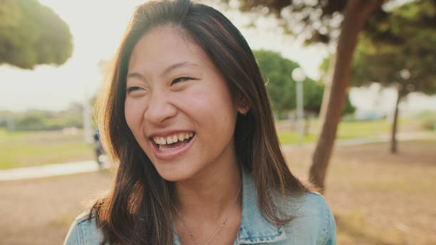 istock Close up, young woman posing at camera while standing in park. Looking at camera 1456354057