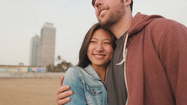 istock Couple in love spending time together standing on the beach 1456354069