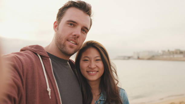 istock Laughing couple talking on video call 1456354107