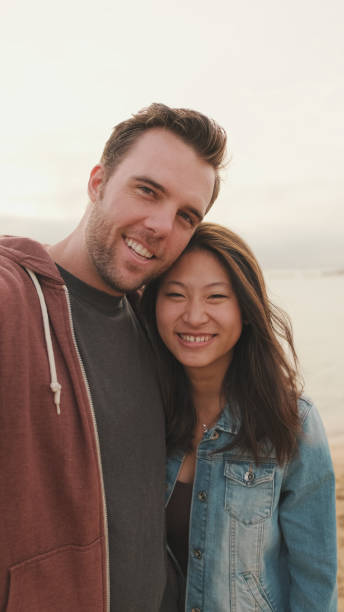 istock Laughing couple talking on video call 1456354111