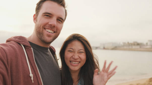istock Laughing couple talking on video call 1456354112
