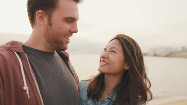istock Laughing couple talking on video call 1456354115