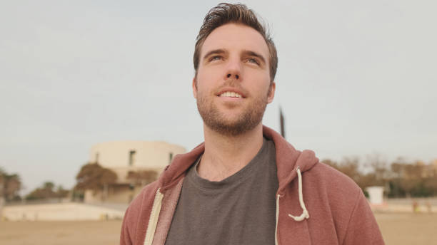 istock Young man enjoying walk on the beach 1456354143