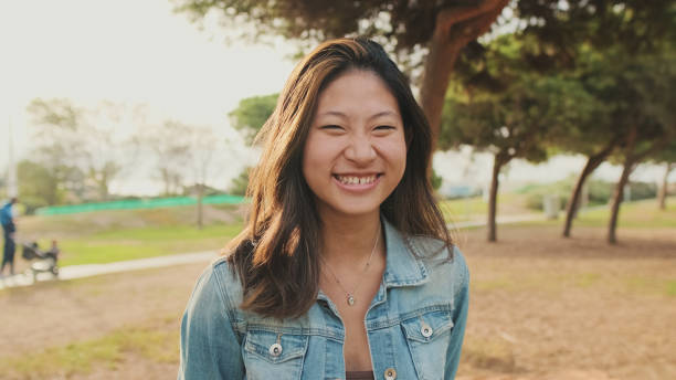 istock Close up, young woman posing at camera while standing in park. Looking at camera 1456354232