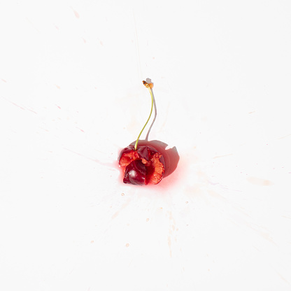 Squashed red cherry berry fruit on white background. Red ripe fruit concept. Healthy food idea.
