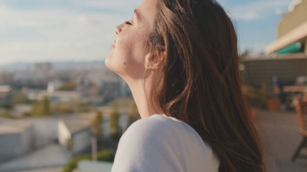 istock Young woman enjoying beautiful view while standing on the balcony 1456355422