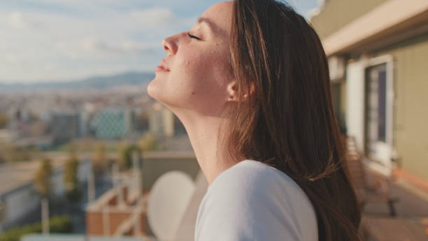 istock Young woman enjoying beautiful view while standing on the balcony 1456355451