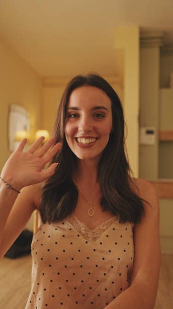 Young woman in pajamas smiling while standing in the kitchen