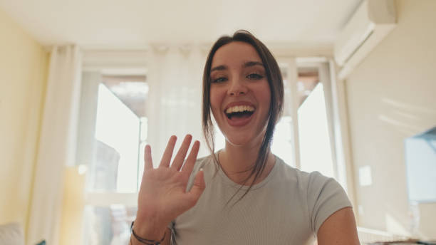 istock Young woman talking on video call using laptop while sitting in apartment 1456355639