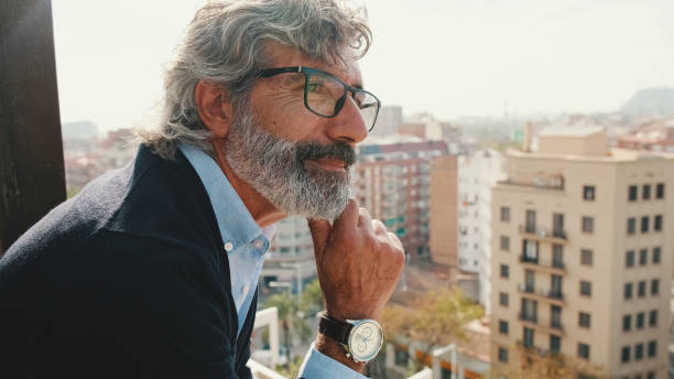 istock Senier enjoys the view standing on the balcony 1456355815