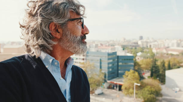 istock Senier enjoys the view standing on the balcony 1456355818