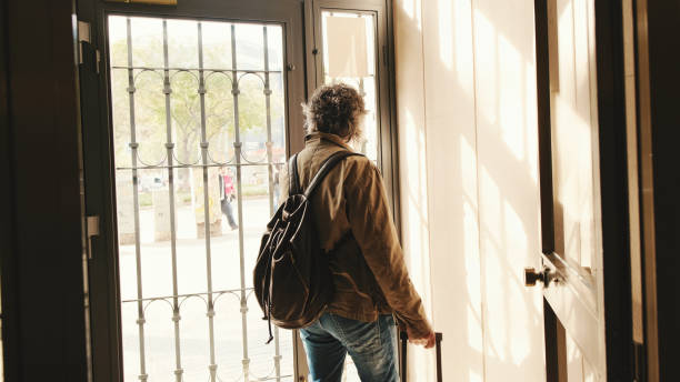 istock Middle aged man leaving home with luggage 1456356187