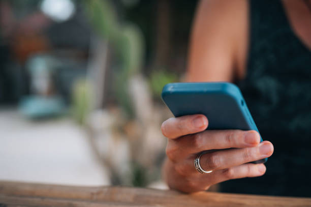 istock Woman  using a mobile phone outdoors 1456362753