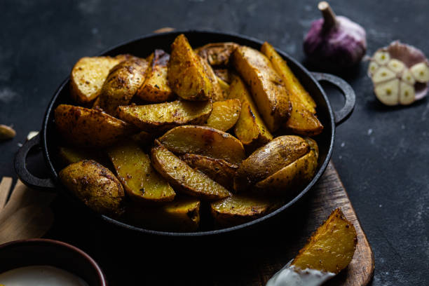 istock fried potatoes Rustic potato with garlic and spices 1456365195