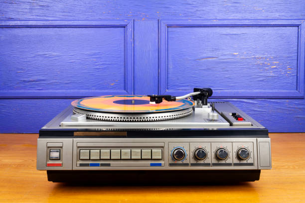 istock Vintage turntable vinyl record player with blue and orange vinyl 1456366235