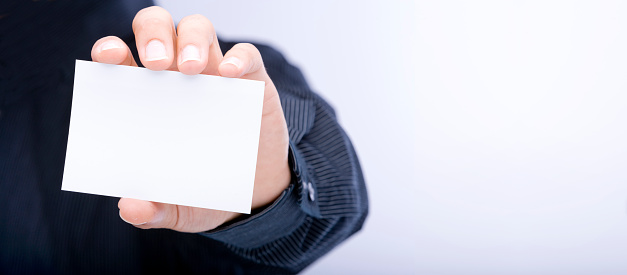 White index card in the hand of a businessman