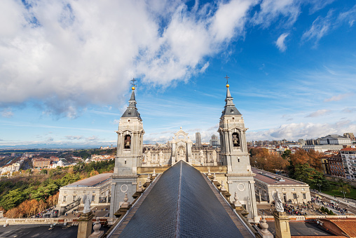 Madrid, Spain - Dec 10th, 2022: Madrid Royal Palace in Baroque style, in the past used as the residence of the King of Spain, and the Almudena Cathedral (Catedral de Santa Maria la Real de la Almudena). Plaza de la Armeria, Community of Madrid, Spain, southern Europe.