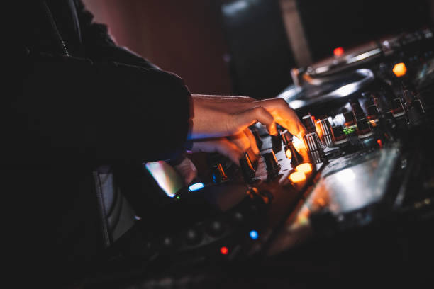 istock Unrecognizable dj hands playing on mixer in nightclub. 1456368039