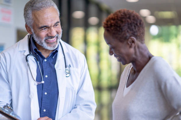 istock Patient and doctor discussing and smiling 1456372225