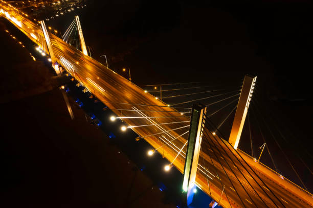 istock suspension bridge over the river at night (aerial) 1456373171