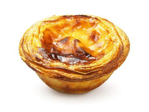 A pastel de nata or pastel de Belém, Portugal's most famous pastry, a creamy baked egg custard tart with a burnt top and flaky crust. The sweet dessert is isolated on a white background.
