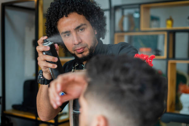 istock male stylist performs haircut to a client 1456373801