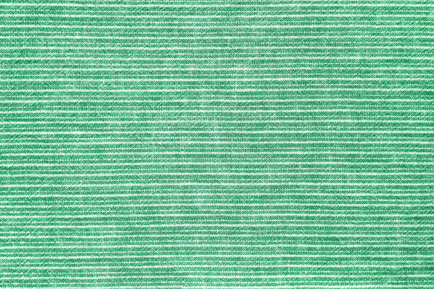 Natural linen texture as background. Cotton fabric with green and white line striped pattern, texture close up, top vies, flat lay. Backdrop, wallpaper. Matereal for clothes, curtain and upholstery