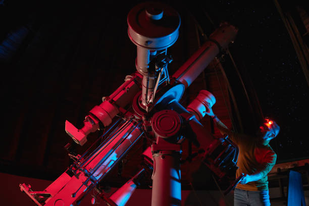 istock Astronomer with a big astronomical telescope in observatory doing science research of space and celestial objects. 1456374662