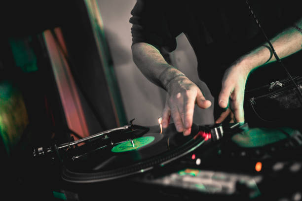 istock Unrecognizable dj mid section playing on mixer in nightclub. 1456375534