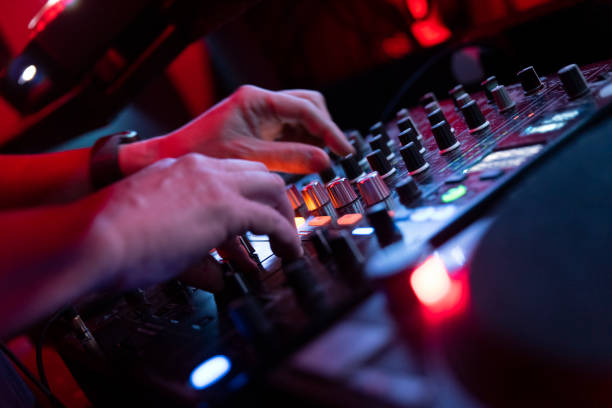 istock Unrecognizable dj hands playing on mixer in nightclub. 1456375541