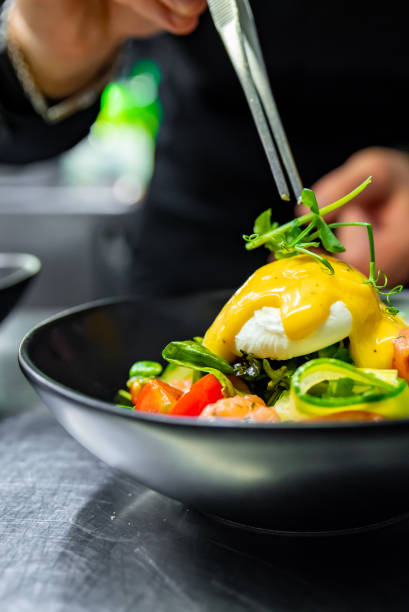 istock Chef in restaurant kitchen cooking salad 1456375833
