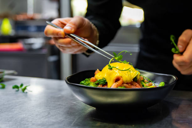 istock Chef in restaurant kitchen cooking salad 1456375884