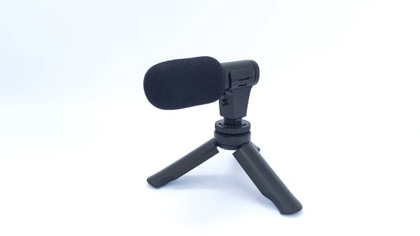 istock Close up of mini microphone with tripod on white background 1456377912