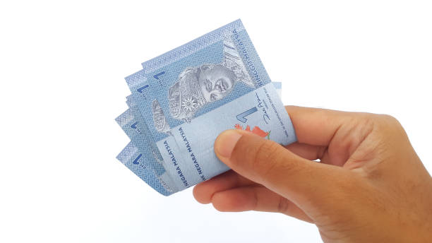 istock Hand holding Malaysian Ringgit money on white background 1456378688