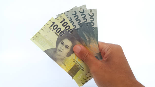istock Hand holding Indonesian Rupiah money on white background 1456378718