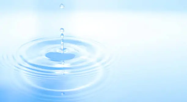 Photo of Waves of water are caused by falling droplets. close-up view.