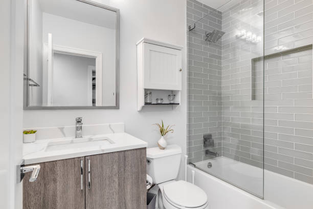 istock A bathroom with a wood cabinet and grey tiled shower. 1456385193