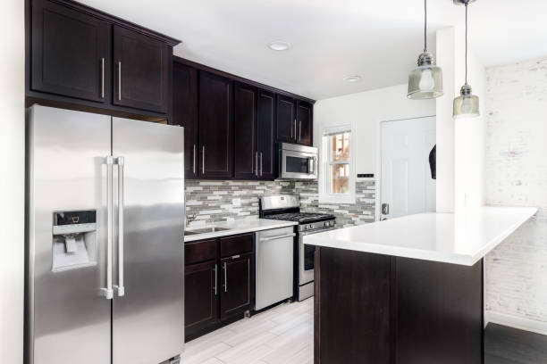 a small kitchen with wood cabinets and white countertop. - domestic kitchen contemporary domestic room lifestyles imagens e fotografias de stock