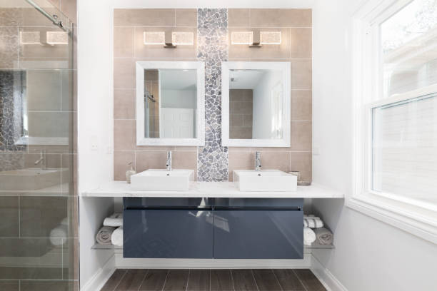 istock A modern bathroom with a blue cabinet and tile wall. 1456385626