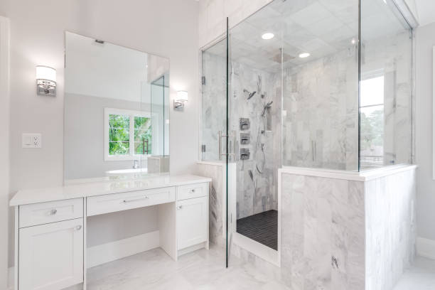 istock A white, luxury bathroom with a tiled walk-in shower. 1456385744