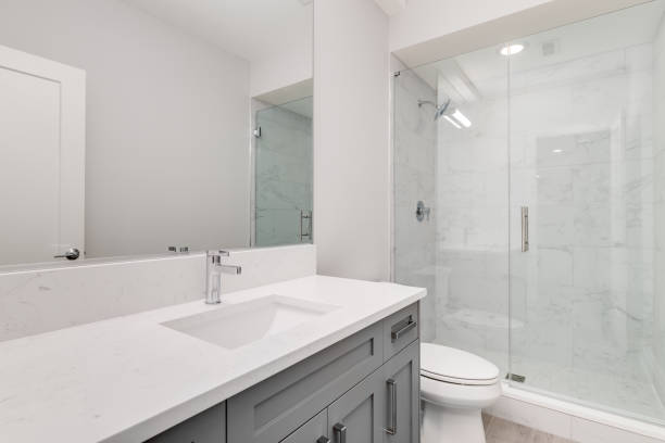 istock A white bathroom with a marble tiled shower. 1456386271