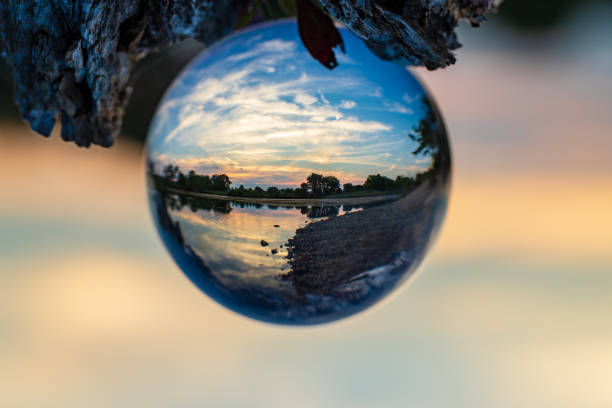 istock A sunset on a lake through a clear glass ball. 1456386435