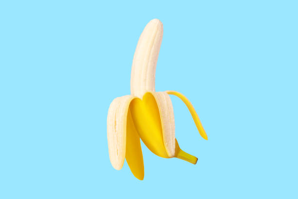 istock Fresh raw yellow banana peeled in flight. On a blue background. 1456387052