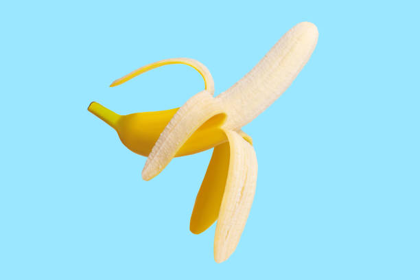 istock Fresh raw yellow banana peeled in flight. On a blue background. 1456387086