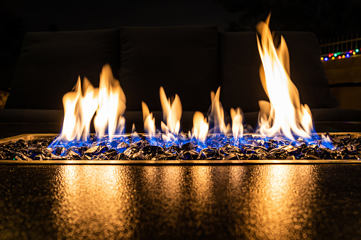 A close-up of the flames in a home fire pit in long exposure.