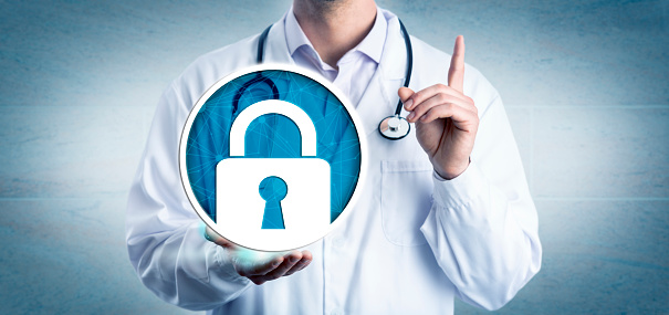 Unrecognizable cardiologist urging for data security in health care by holding a locked padlock icon. Information technology and healthcare metaphor for cybersecurity, privacy, secure health records.
